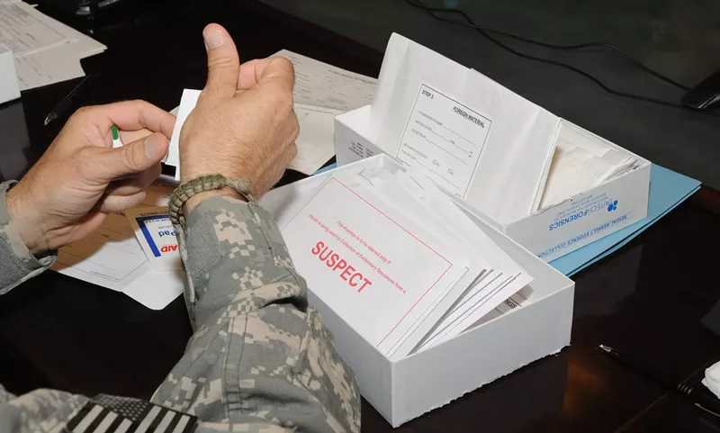 Image: A U.S. military medical official learns how to use a sexual assault evidence collection kit in 2010.