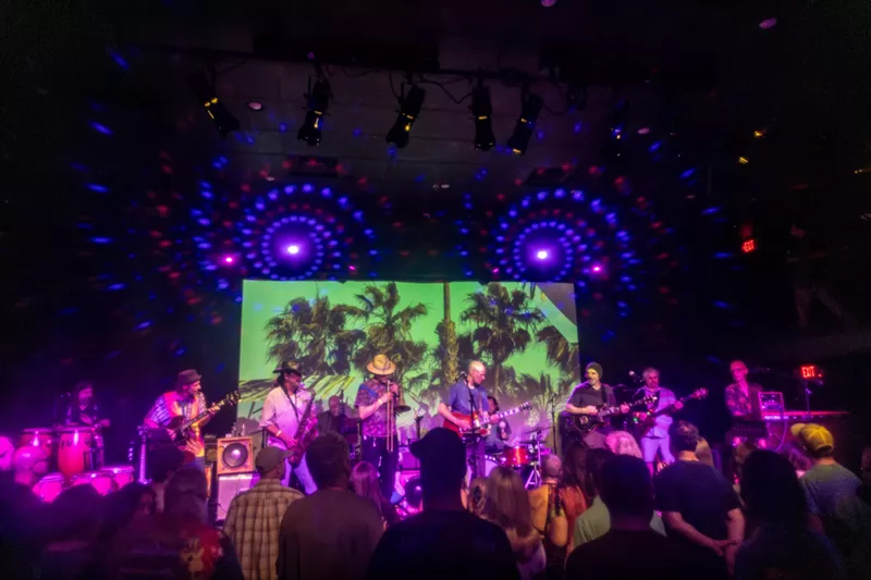 Image: A group of musicians and band members on stage