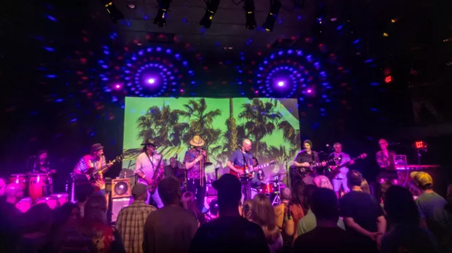 A group of musicians and band members on stage