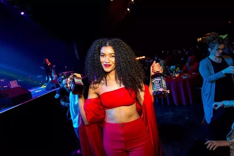 Image: Rapper Sam Lao showing off her Dallas Observer music awards.