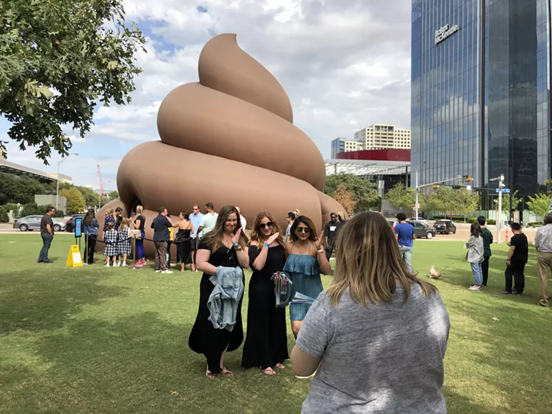 Image: Kelly Gardner, Lisa Manz and Minal Patel pose for a photo in front of a giant, billowy turd that popped up on the northeastern part of Klyde Warren Park.