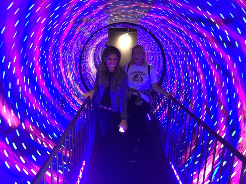 Image: Neda Khalilian (left) and Wendy Long (right) take a mind-dismantling walk through the Vortex Tunnel at the Museum of Illusions.