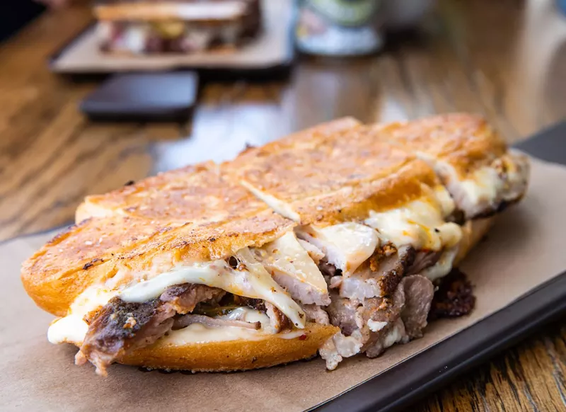 Image: The "Cuban-ish" sandwich at Brown Bag provisions with porchetta, roast pork shoulder, Muenster cheese, pickles and whole grain mustard for $13