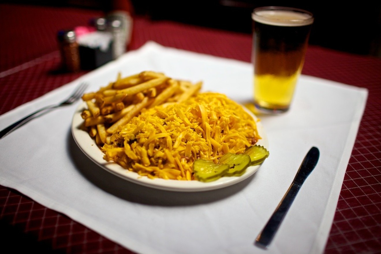 High piles of shredded cheddar are a common sight at Angry Dog. There's a hot dog with chili in there somewhere.