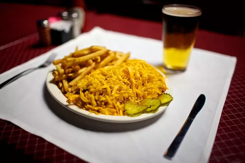 Image: High piles of shredded cheddar are a common sight at Angry Dog. There's a hot dog with chili in there somewhere.