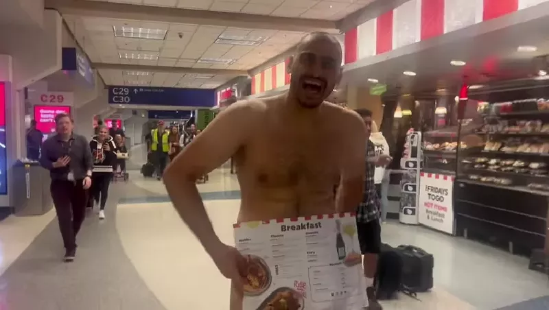 Image: Journalist Derek Smith exchanged a few words with the naked guy who strolled through one of the terminals at Dallas Fort Worth International Airport on Wednesday.