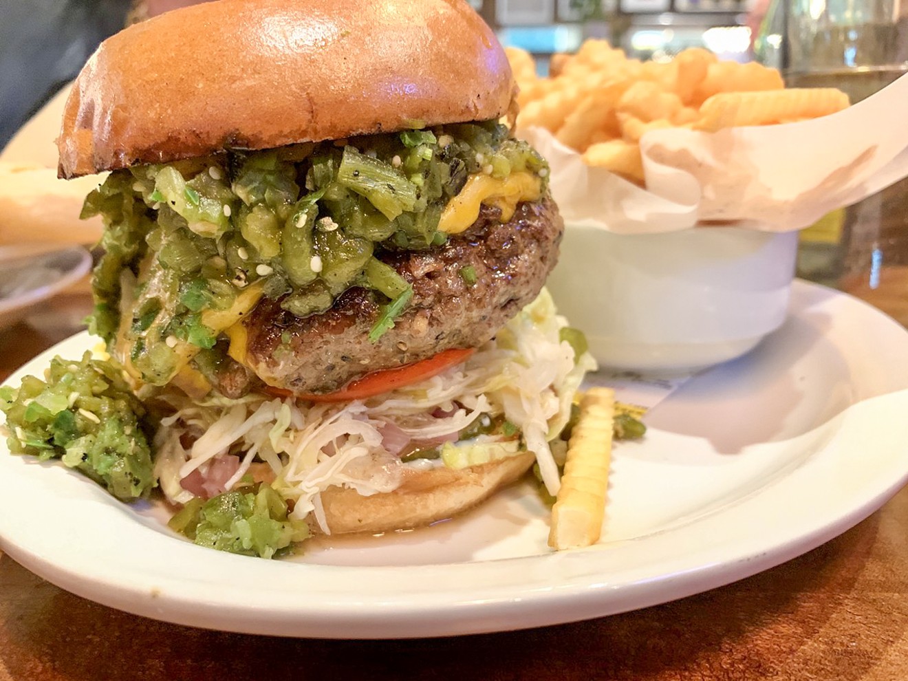 The cheeseburger at Desert Racer with added-on green chiles for $17 features a half-pound chuck and shoulder ground patty, shredded lettuce, onion and tomato.