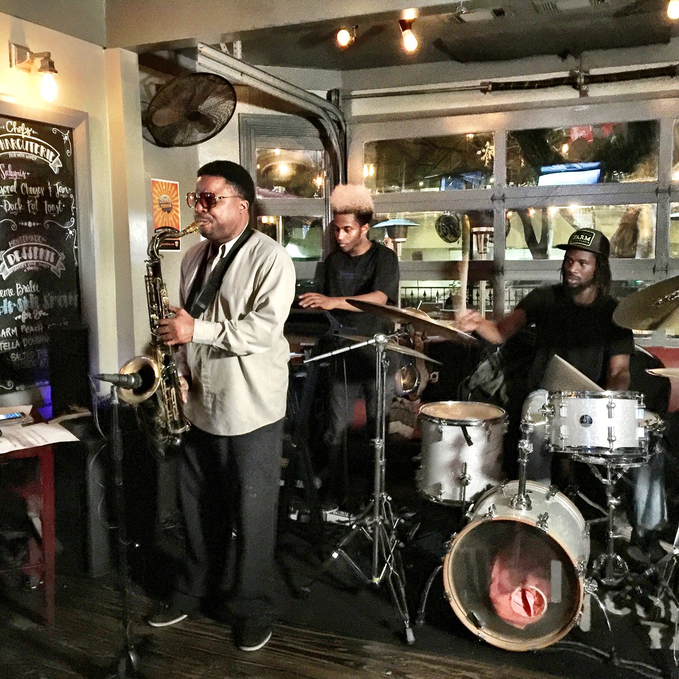 Jason Davis on saxophone, Byron Crenshaw on bass and Frank Moka on drums perform live at The Common Table in Uptown.