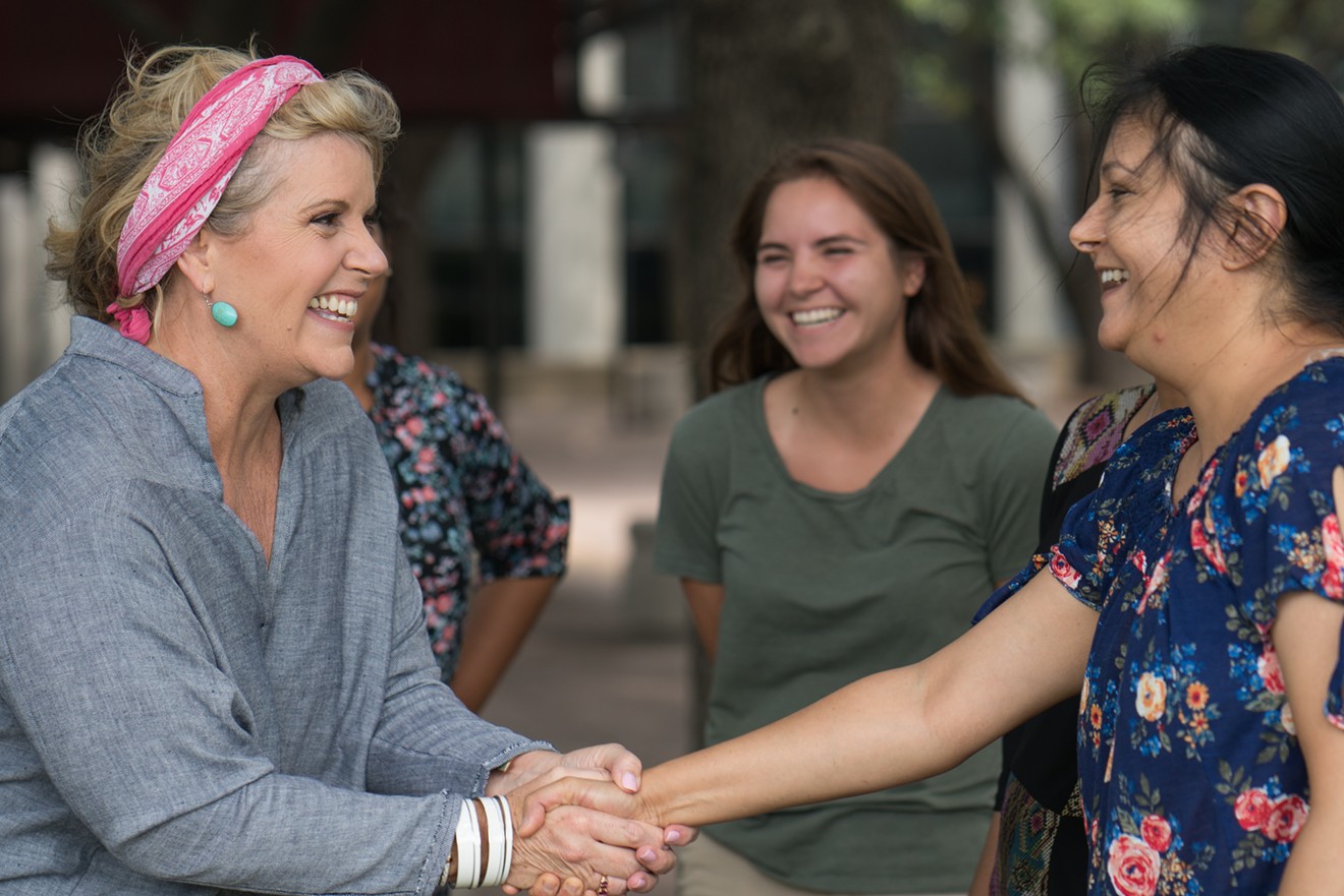 Lillian Salerno (left) greets potential voters in Dallas.