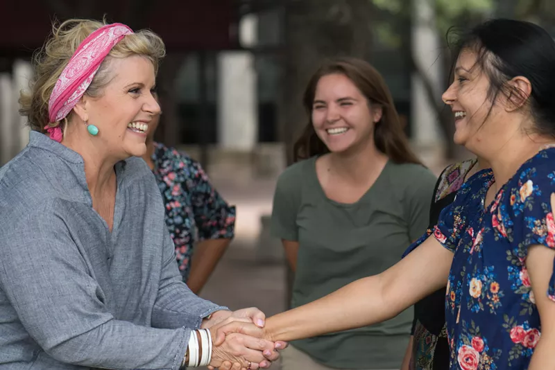 Image: Lillian Salerno (left) greets potential voters in Dallas.