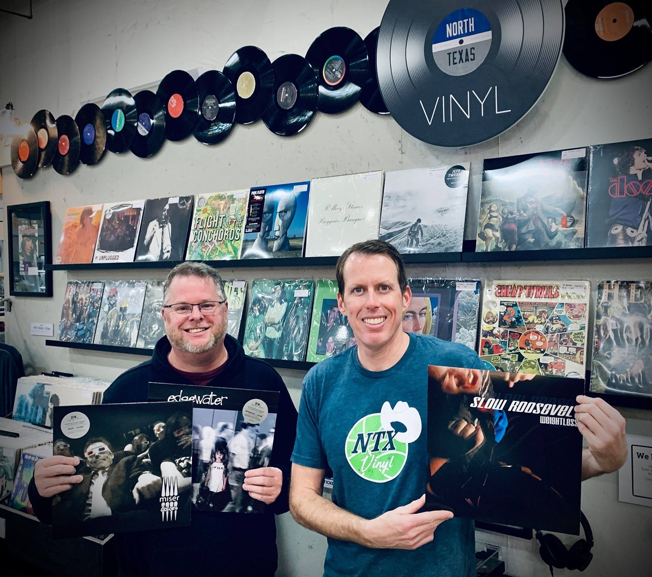 Travis Hill (left) and GI Sanders, at NTX Vinyl, are helping local nonprofits through rereleases of local albums from the early 2000s.
