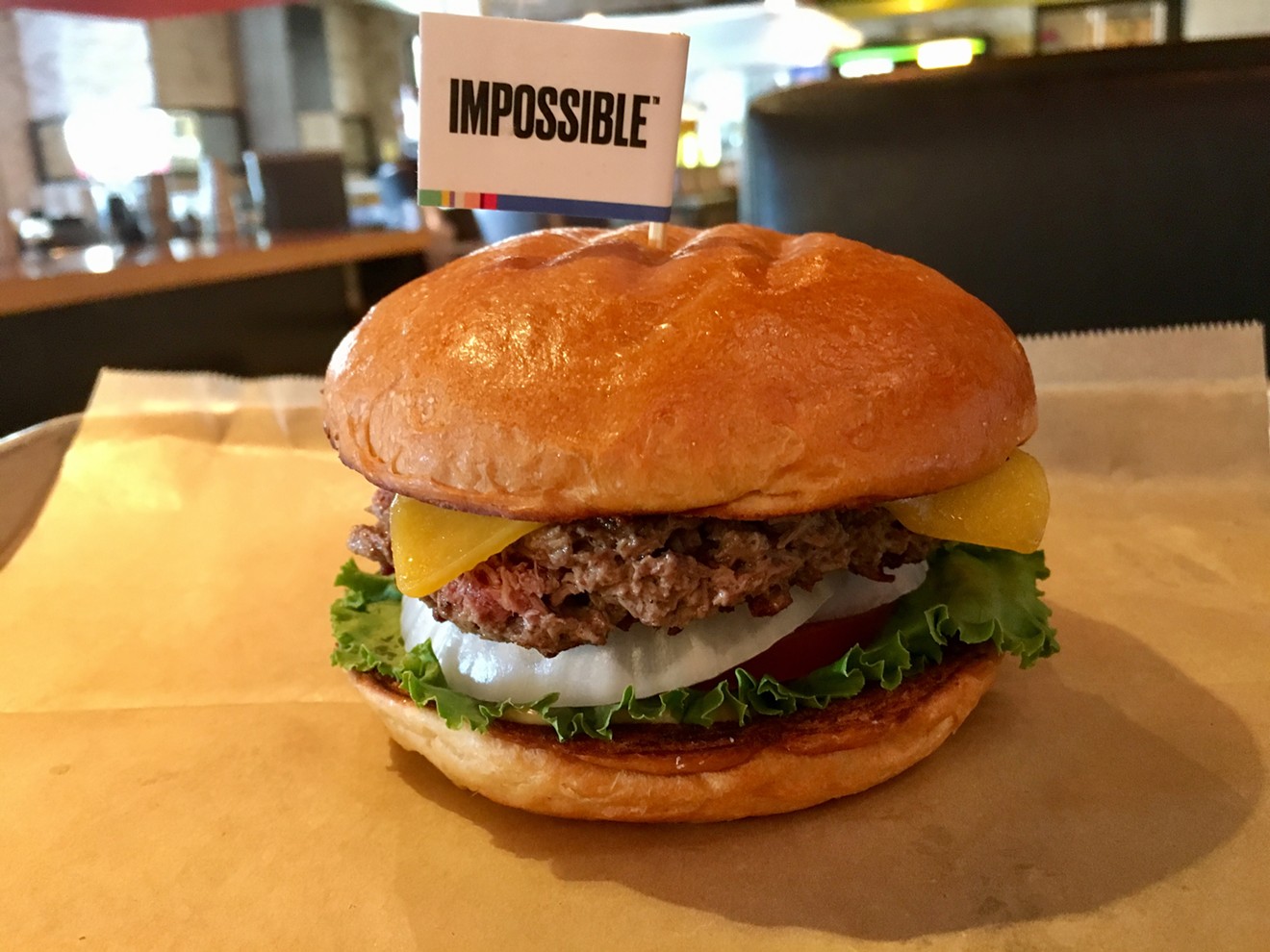 Hopdoddy's Impossible Burger uses an Impossible Foods patty, Tillamook cheddar, green leaf lettuce, white onion, tomatoes and “Sassy Sauce” on a brioche bun.