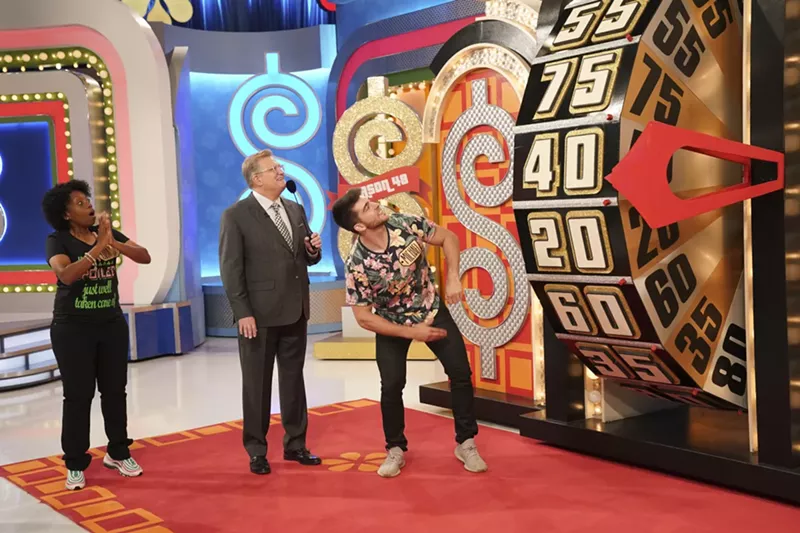 Image: A contestant on the long running CBS game show The Price is Right hosted by Drew Carey, middle, spins the big wheel during the Showcase Showdown.