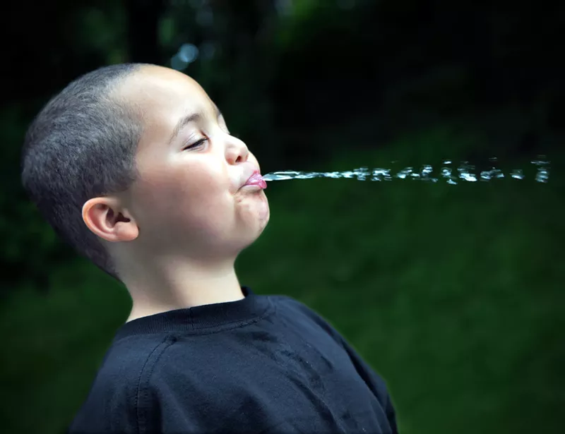 Image: a kid spitting