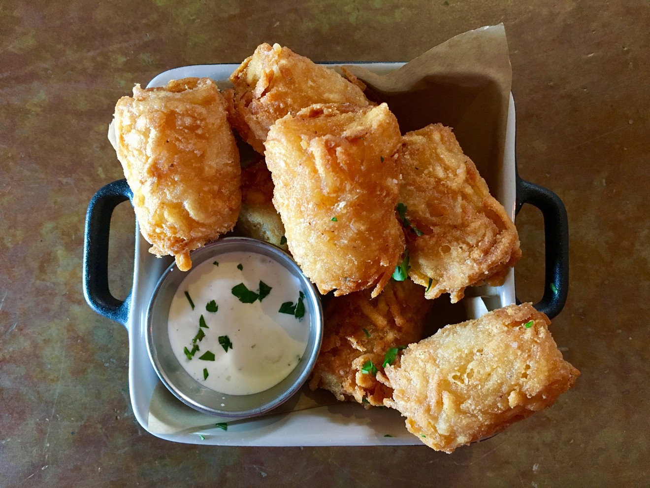 IdleRye's housemade tater tots are served with an oniony dipping sauce.