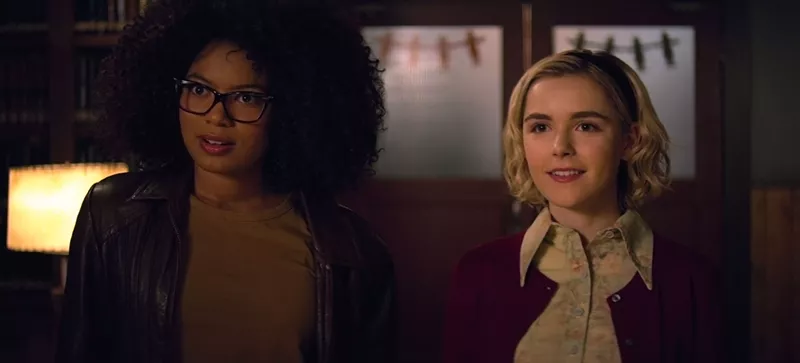 Image: Kiernan Shipka (right) stars as America’s favorite teenage witch, who talks casually of patriarchy and intersectionality with her best friend, Roz (Jaz Sinclair), in Netflix’s Chilling Adventures of Sabrina.
