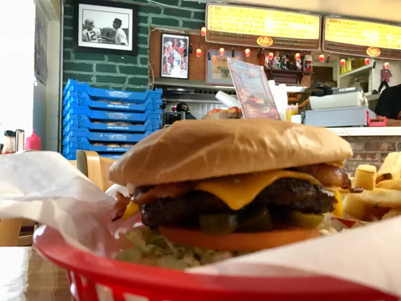 Image: A Texas Cheeseburger at Del's, with bacon, cheese, jalapenos and hickory barbecue sauce.