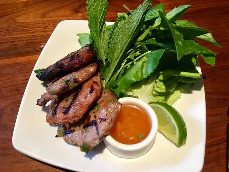 Image: Meatballs, smash-flattened into the grill, and served with Thai basil and butter lettuce for $5 at happy hour.