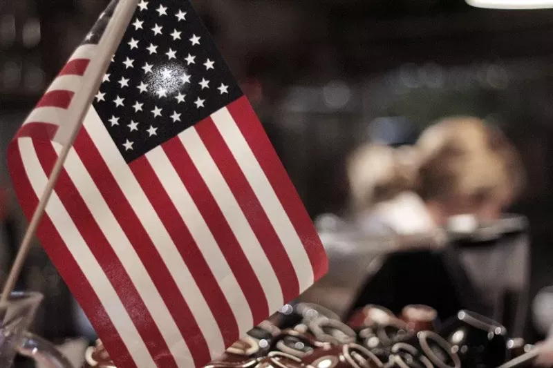 Image: An American flag flies at Oddfellows during the restaurant's election watch party last November. Today, some of Oddfellows staff — immigrants who were born in other countries — will be staying home in protest as part of A Day Without an Immigrant.
