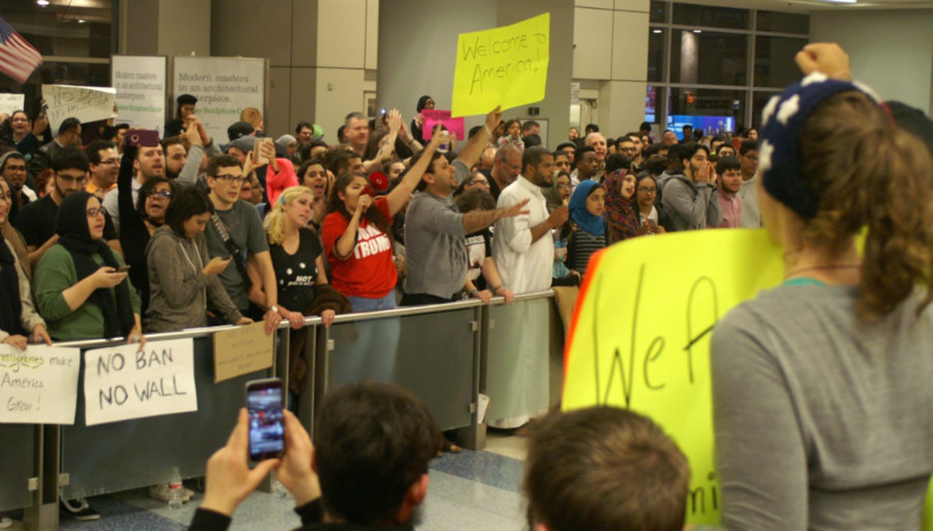 Hundreds of protesters gather at DFW International Airport’s Terminal D Saturday night in support of travelers detained according to President Donald Trump's executive order.