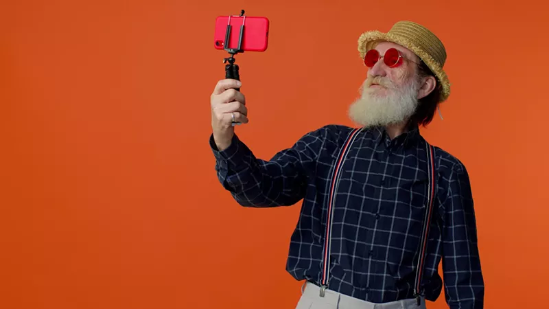 Image: Old man taking a selfie.