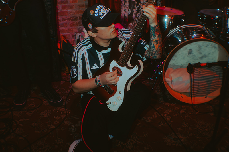Image: Man playing the guitar on the ground