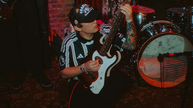 Man playing the guitar on the ground