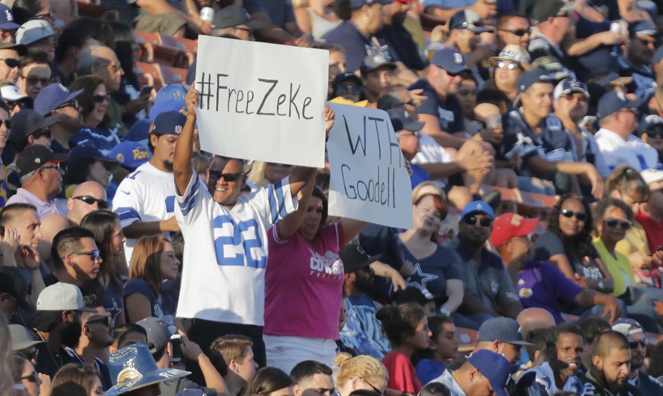 Fans held signs of support for Ezekiel Elliott during an Aug. 12 preseason game against the Los Angeles Rams at the Los Angeles Memorial Coliseum.