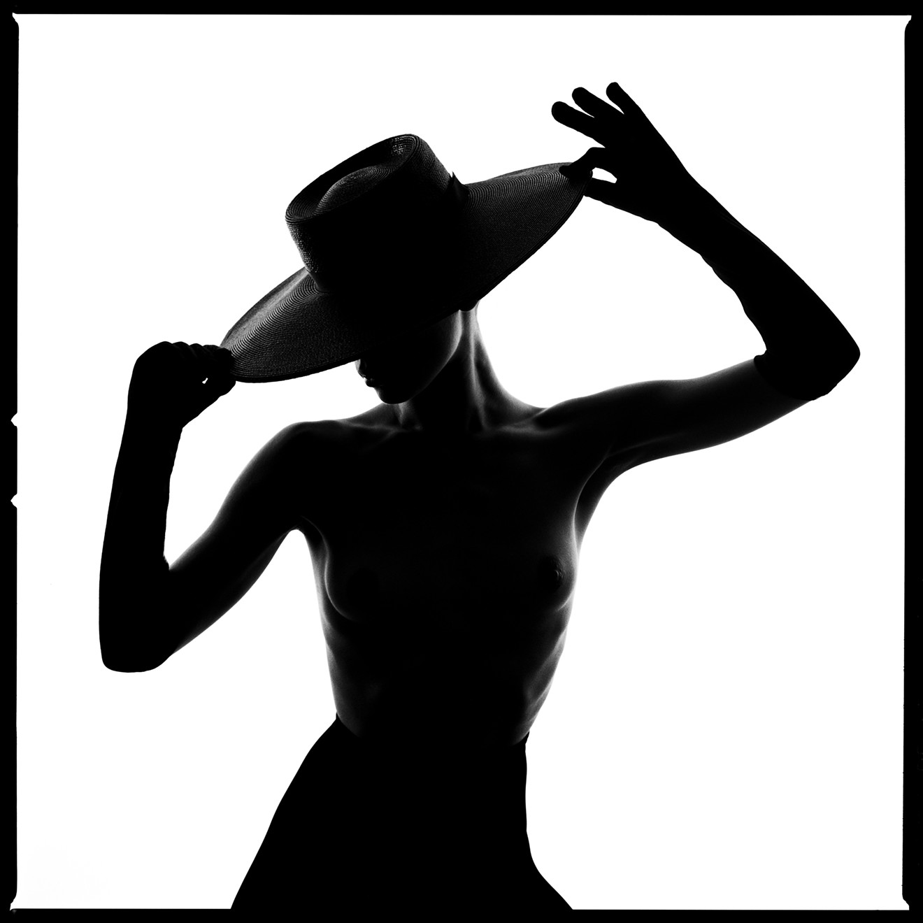 A portrait of a woman wearing a hat included in Tyler Shields's Silhouette series.
