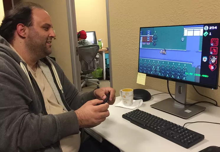 Pixel artist Bobby Frye tests out the Amazon Fire port of BonusXP's Stranger Things: The Game, the first port that allows players to use a controller with the game. - DANNY GALLAGHER