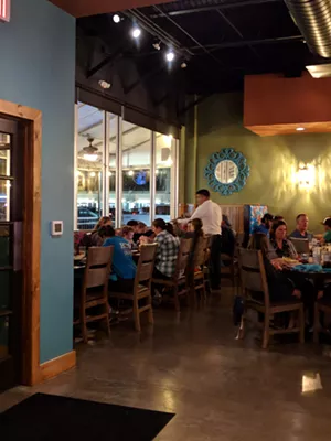 The interior at El Vecino features warm blues, greens and teals and a few brightly-colored booths. - BRIAN REINHART