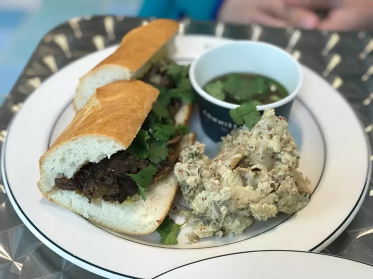 Commissary's French dip ($10) is accented by Vietnamese flavors highlighted by the pho broth served in lieu of au jus. - BETH RANKIN