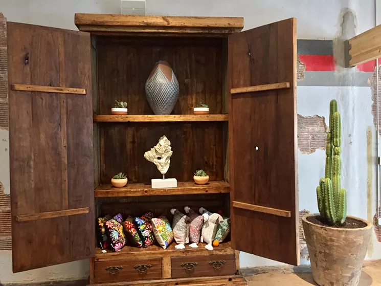 The gallery at Mercado Artesenal is filled with pieces made by artisans from around the world — hand-carved gourds from Peru, pottery from Central America, wooden masks from Michoacán. - GUSTAVO CONTRERAS