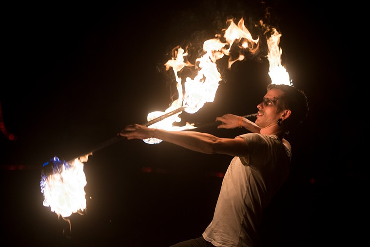 Dalton Sessumes spins a fire staff at a burn festival near Corsicana. - BRIAN MASCHINO