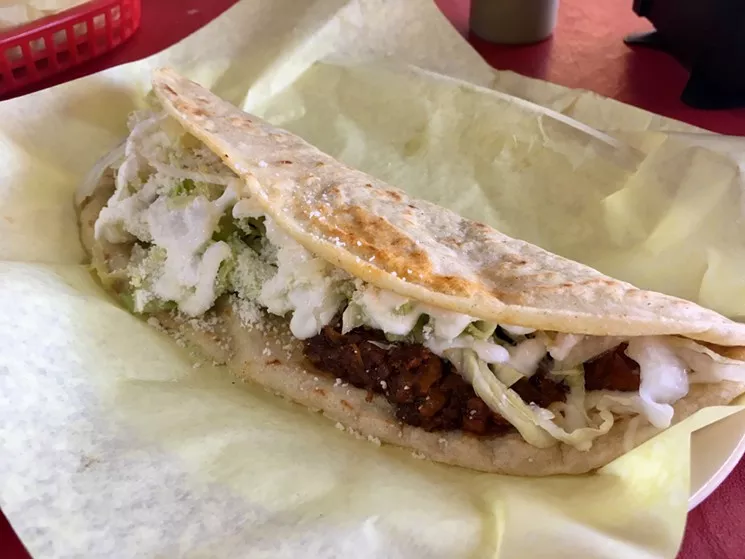 Corn tortilla with melted cheese, cotija crumbles, sour cream and chicharron prensado at Aca Las Tortas - NICK RALLO