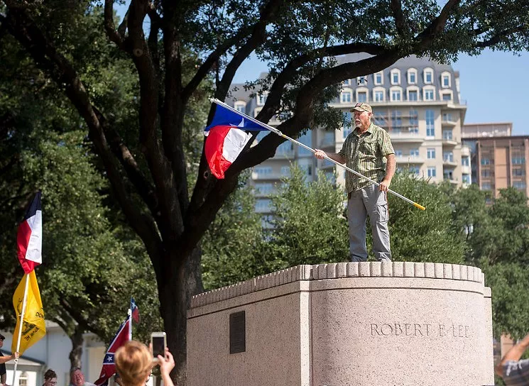 The really tough part of this protest came when the poor guy had to get down from there. And, uh ... about that flag. Oh, forget it. - BRIAN MASCHINO