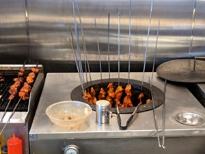 Tandoori chicken on skewers and in the oven just behind the buffet line. - BRIAN REINHART