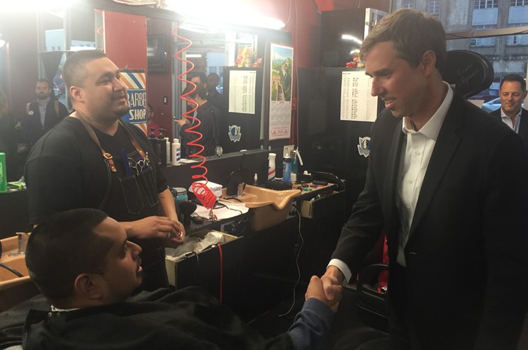 O'Rourke (right) shakes hands with Genaro Menchach at Bishop Barbers, owned by Marcus Santillan, on Jefferson Boulevard. - DANNY GALLAGHER