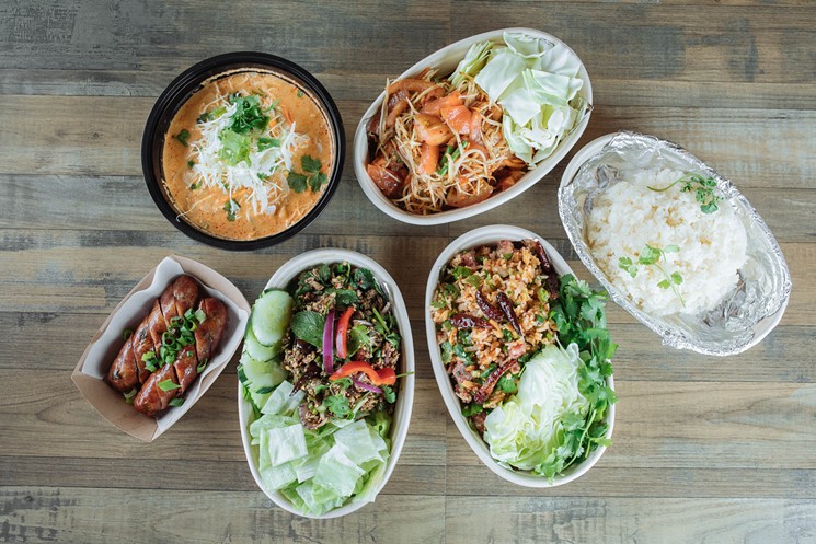 From top left to right, clockwise: Khao Poon soup, papaya salad, sticky rice, stir-fry rice, Laab salad, Lao sausage at Zaap Kitchen - KATHY TRAN