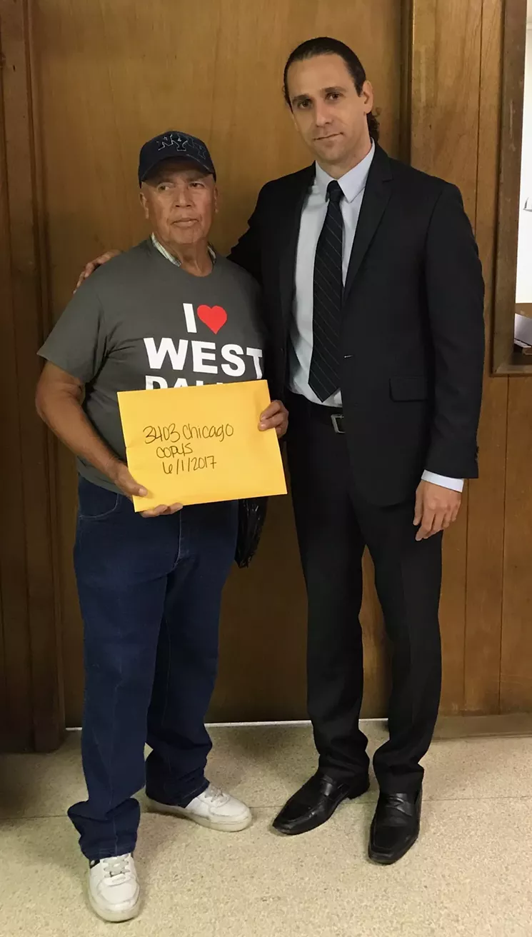 A federal lawsuit against Khraish Khraish (right) claims he failed to give Julian Campos documents after a real estate closing, but Khraish says this is a photo of Campos with his closing documents. The closing also was videotaped. - HMK LTD.