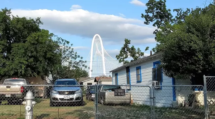 Erection of a flashy new suspension bridge to West Dallas set off a wave of land speculation and displacement. - JIM SCHUTZE