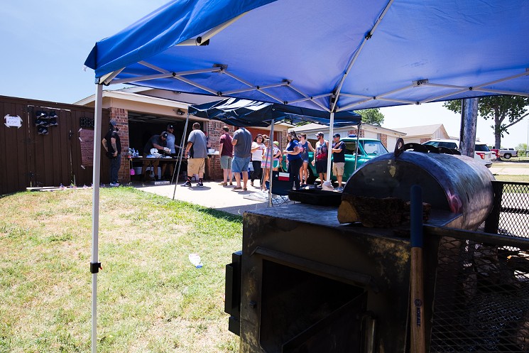 A dozen people brave the heat and line up in a Fort Worth neighborhood for Dayne Weaver's underground barbecue. - CHRIS WOLFGANG