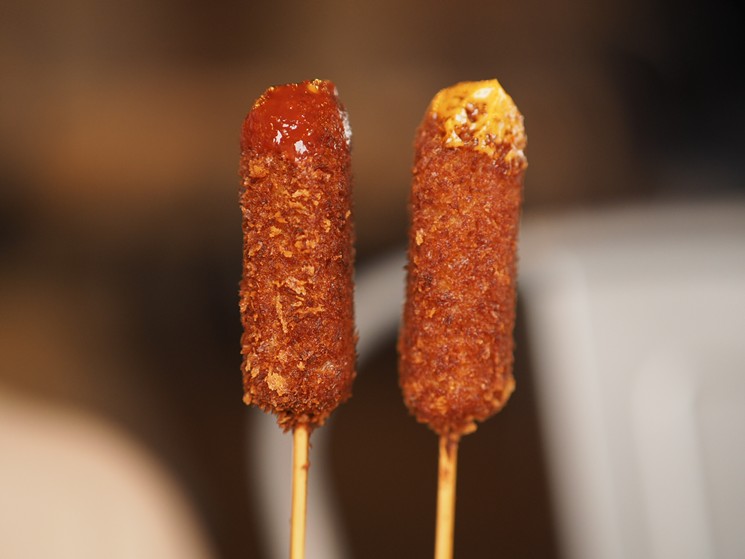 The corn dogs at Sumo Shack are an homage to katsu pork, breaded in a deeply crispy Panko batter and served with two dipping sauces for less than $5. - SUMO SHACK