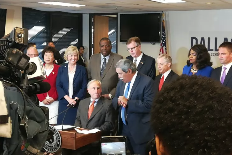 Dallas ISD Superintendent Michael Hinojosa speaks to Texas Gov. Greg Abbott in October. - STEPHEN YOUNG