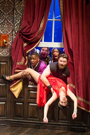 Cast and crew of the play The Murder at Haversham Manor try to pull an unconscious actress (Jamie Ann Romero) out of the window in The Play That Goes Wrong. - JEREMY DANIEL