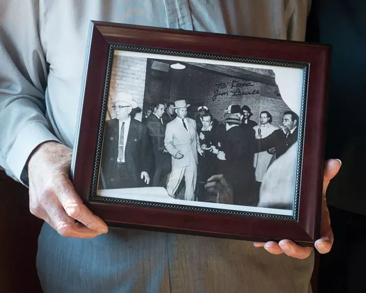 Former homicide detective Jim Leavelle was handcuffed to Lee Harvey Oswald the day Jack Ruby shot Oswald. He's holding Bob Jackson's famous photograph immortalizing the moment. - EXPLOREDINARY