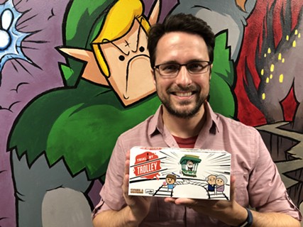 Cyanide & Happiness co-creator Rob DenBleyker shows off a copy of Explosm Entertainment and Skybound Games' newest card game Trial By Trolley that will be in players' hands by the end of the year. - DANNY GALLAGHER