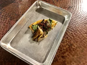 A slice of the Bella pizza, looking sad because people — vegans and meat-eaters alike, it seemed — were getting competitive over who was getting slices (even though there was plenty to go around). - TAYLOR ADAMS