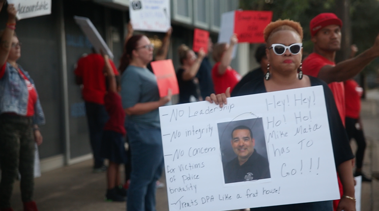 Local activist Pamela L. Grayson stands outside the Dallas Police Association building with protesters calling for the resignation and firing of Mike Mata, DPA president. - JACOB VAUGHN