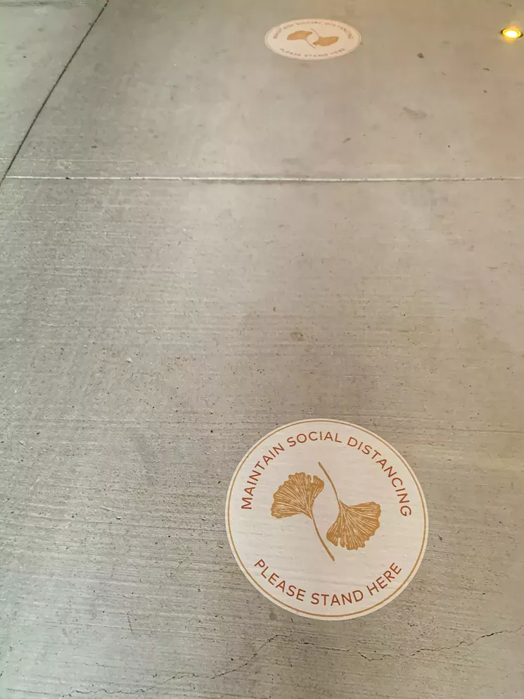Many establishments are doing this; Uchi just has fancy, branded versions of decals to help people maintain distance from others. - TAYLOR ADAMS